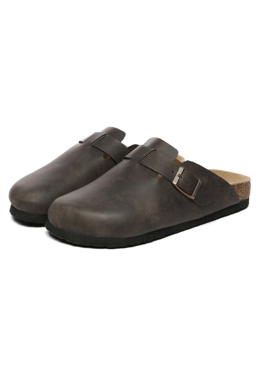 Pair of brown leather clogs on a white background